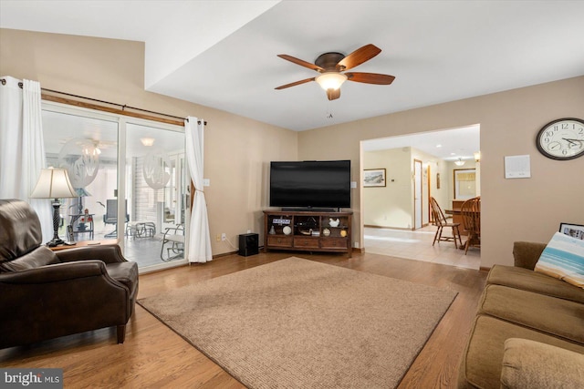 living room with lofted ceiling, ceiling fan, and hardwood / wood-style flooring