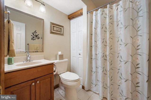 bathroom with vanity, tile patterned flooring, toilet, and curtained shower