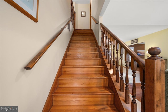 stairs with hardwood / wood-style flooring