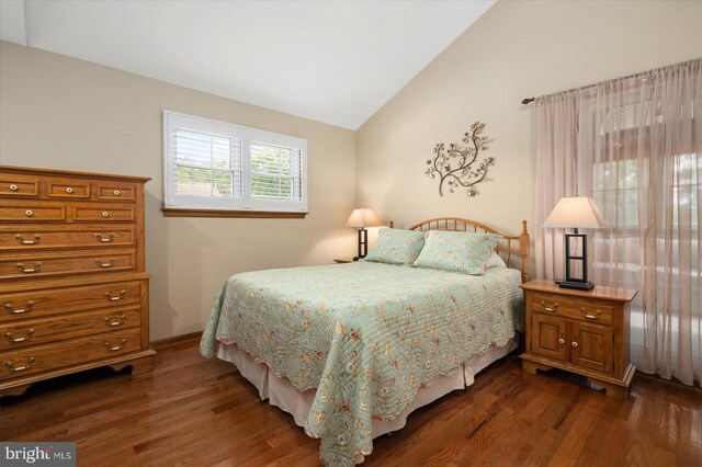 bedroom featuring vaulted ceiling and dark hardwood / wood-style floors