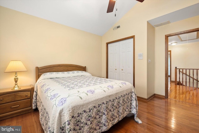 bedroom featuring a closet, lofted ceiling, ceiling fan, and hardwood / wood-style flooring