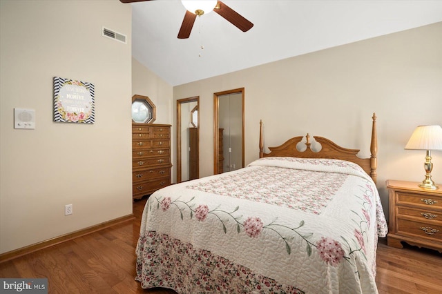 bedroom with ceiling fan, vaulted ceiling, and hardwood / wood-style floors