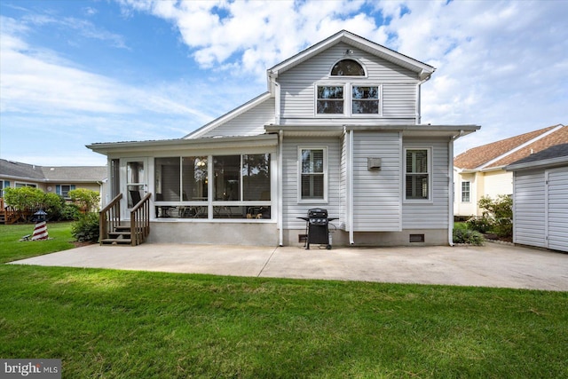 back of house featuring a lawn, a sunroom, and a patio area