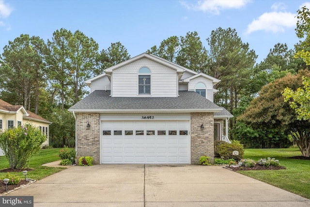 view of front of house featuring a garage and a front lawn