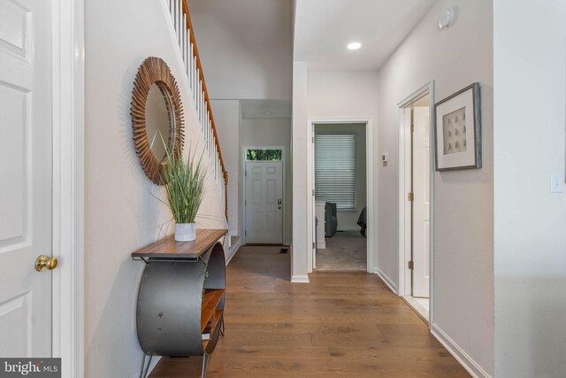 hall with hardwood / wood-style flooring