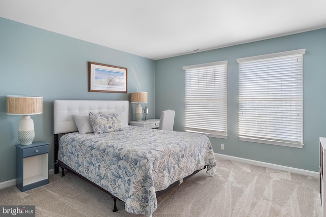 carpeted bedroom with multiple windows