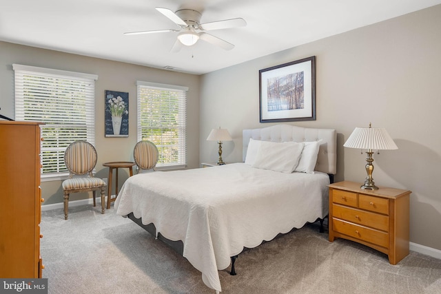 bedroom with ceiling fan and light carpet