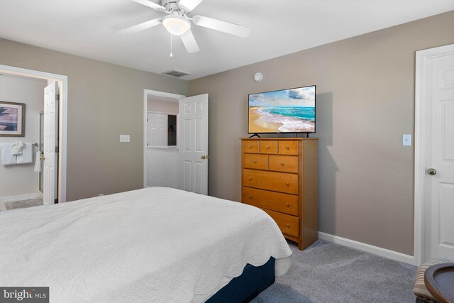 bedroom with ceiling fan, connected bathroom, and carpet floors