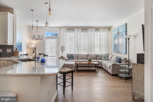 living room with dark hardwood / wood-style flooring and sink