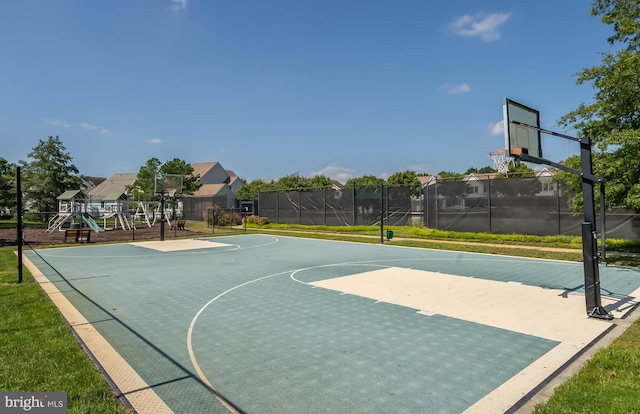 view of sport court featuring a playground