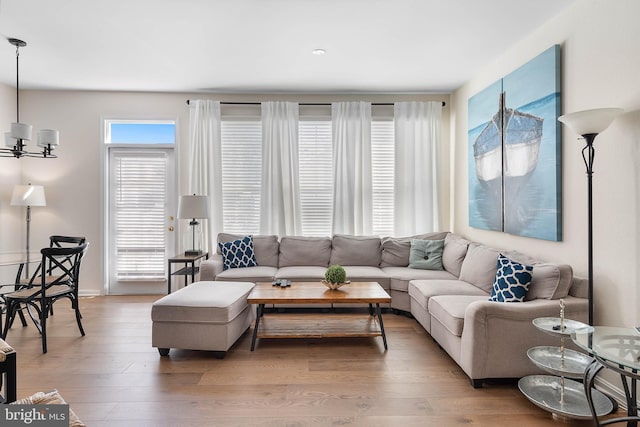 living room featuring hardwood / wood-style floors and a notable chandelier