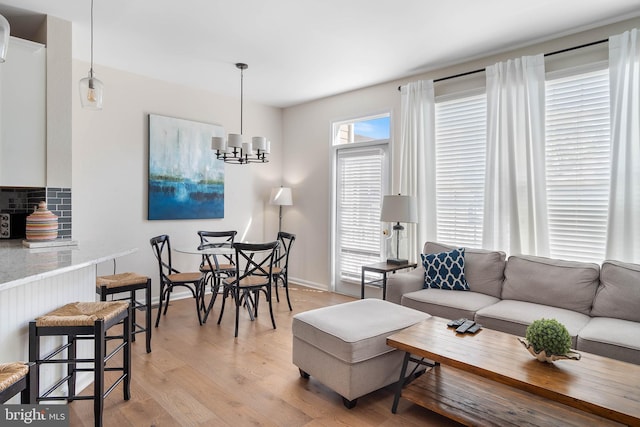 living room featuring a notable chandelier and light hardwood / wood-style floors