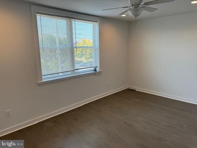 unfurnished room with dark wood-type flooring and ceiling fan