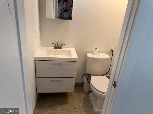 bathroom with vanity, toilet, and tile patterned floors