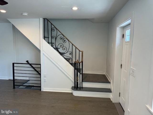 stairway with hardwood / wood-style flooring