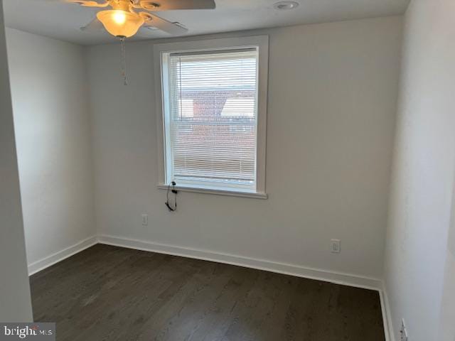 unfurnished room featuring dark hardwood / wood-style floors and ceiling fan