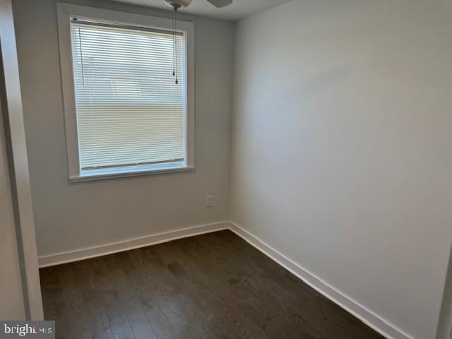 spare room featuring dark hardwood / wood-style floors and ceiling fan