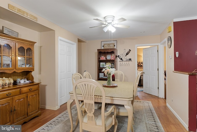 dining room with light wood-type flooring and ceiling fan