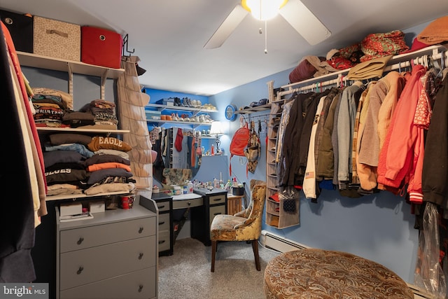 spacious closet with carpet, a baseboard heating unit, and ceiling fan