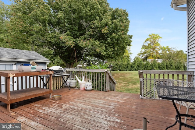 wooden deck featuring a lawn