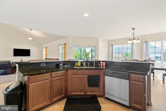 kitchen featuring decorative light fixtures, a chandelier, sink, dark stone counters, and stainless steel dishwasher