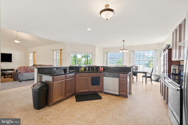 kitchen with appliances with stainless steel finishes, plenty of natural light, a notable chandelier, and pendant lighting