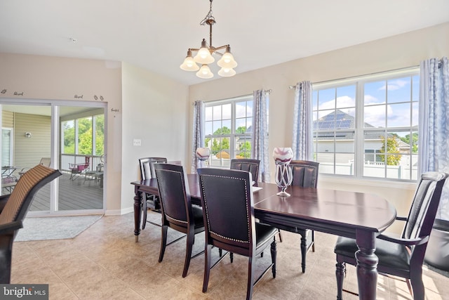 tiled dining space featuring a chandelier