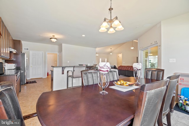 dining area with a notable chandelier and light tile patterned floors