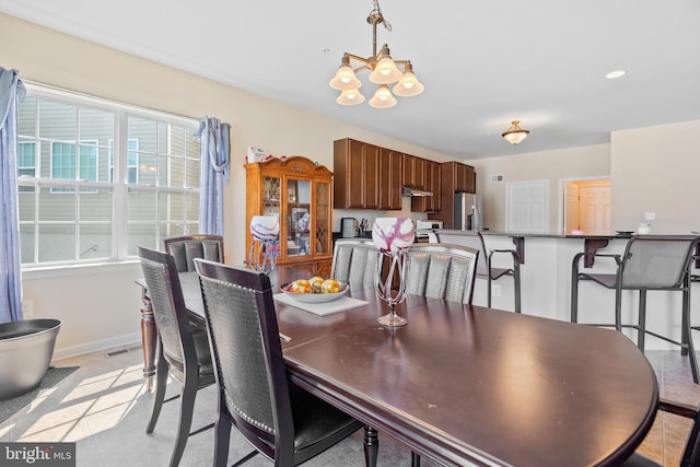 dining space featuring a chandelier and a healthy amount of sunlight