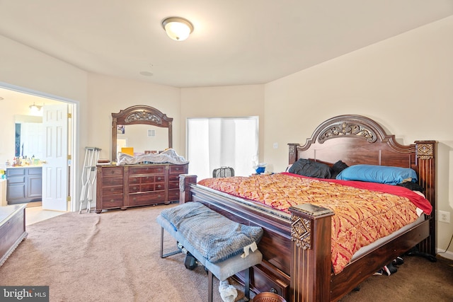 bedroom featuring light carpet and ensuite bathroom