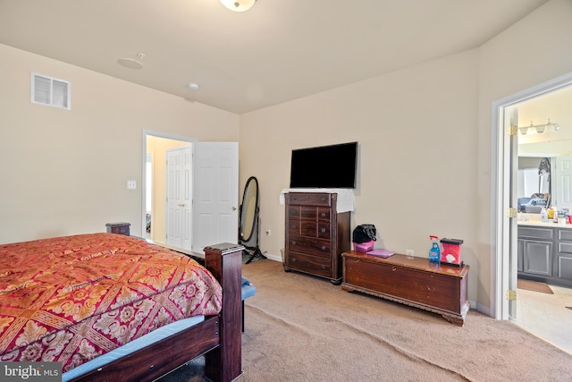 carpeted bedroom with ensuite bath