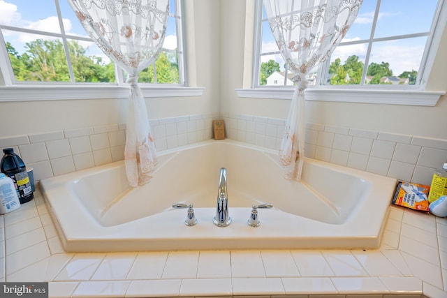 bathroom featuring a relaxing tiled tub