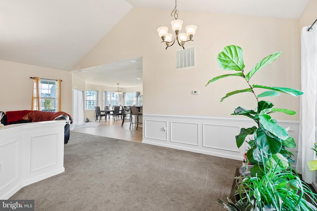 interior space featuring vaulted ceiling and a chandelier