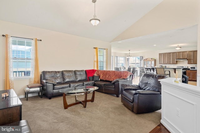 carpeted living room featuring lofted ceiling and a healthy amount of sunlight