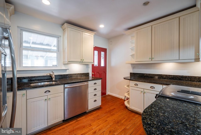 kitchen with sink, stainless steel appliances, light hardwood / wood-style floors, and a healthy amount of sunlight