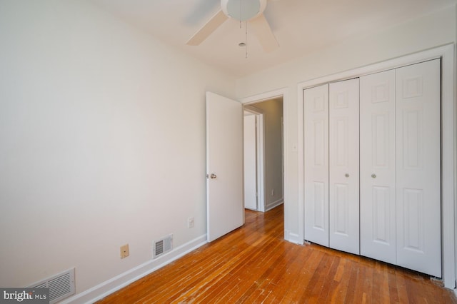 unfurnished bedroom with ceiling fan, a closet, and light hardwood / wood-style floors