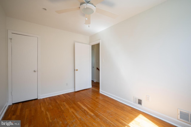 unfurnished bedroom featuring hardwood / wood-style floors and ceiling fan