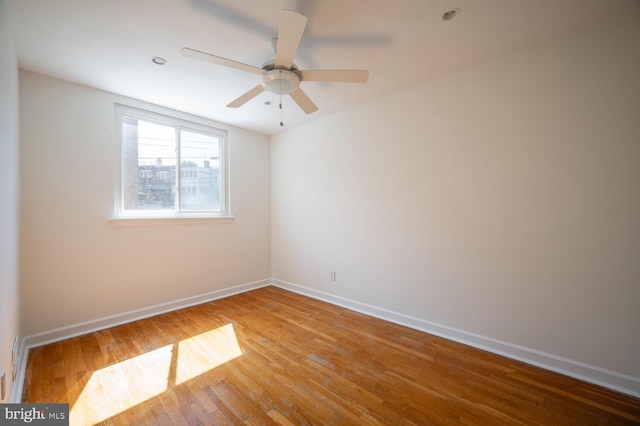 spare room with wood-type flooring and ceiling fan