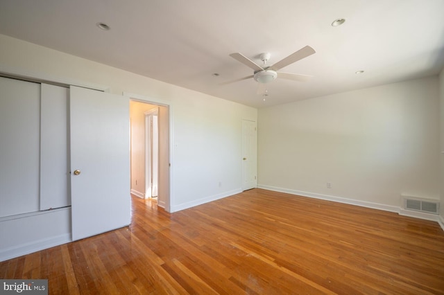 unfurnished bedroom with a closet, ceiling fan, and hardwood / wood-style floors