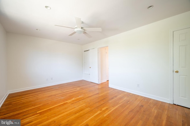 unfurnished room with wood-type flooring and ceiling fan