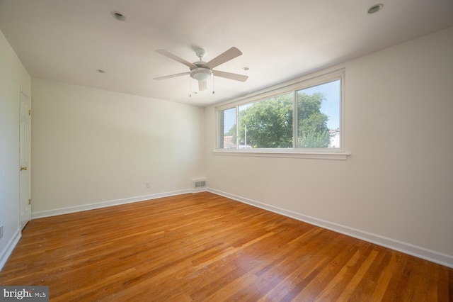 unfurnished room featuring ceiling fan and hardwood / wood-style flooring