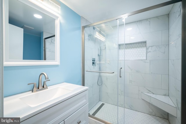 bathroom with walk in shower and vanity