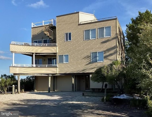 view of property with gravel driveway