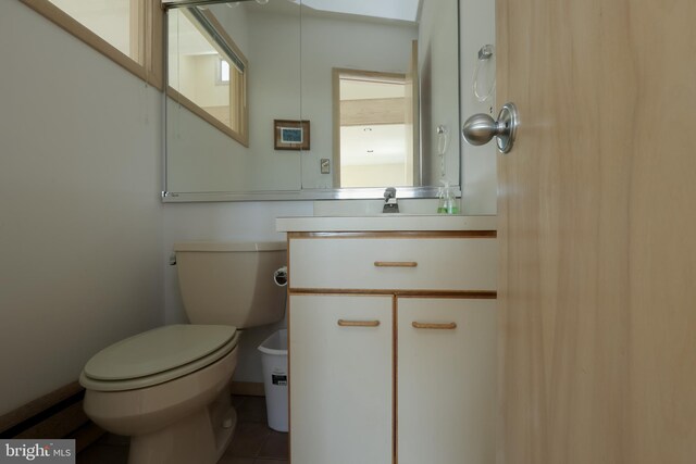 bathroom with vanity, toilet, and tile patterned flooring