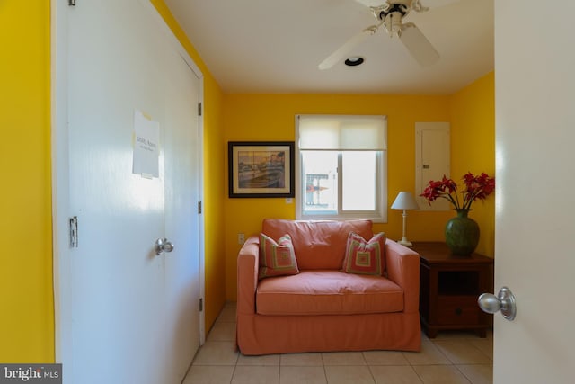 sitting room featuring light tile patterned flooring and ceiling fan