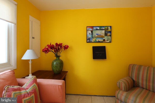 sitting room featuring light tile patterned floors and electric panel