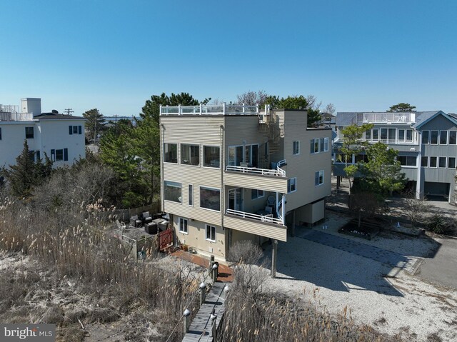 back of property with a balcony