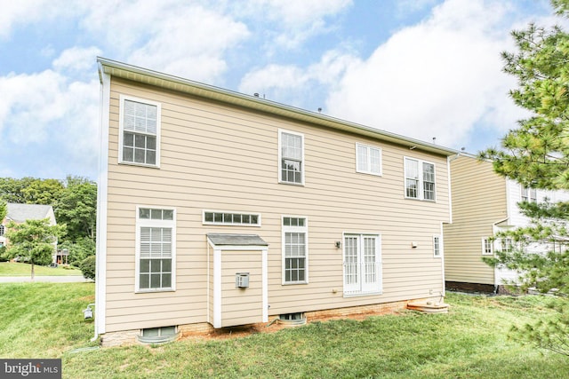 rear view of property featuring a yard