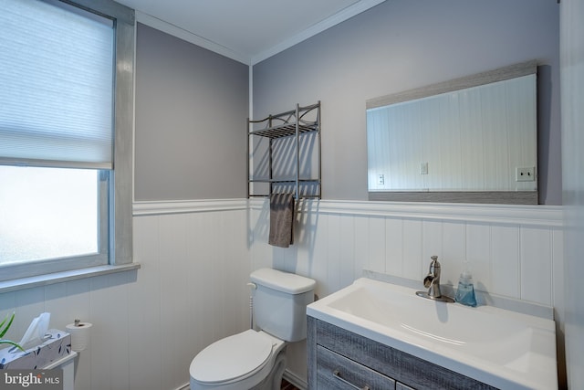 bathroom featuring vanity, toilet, and crown molding