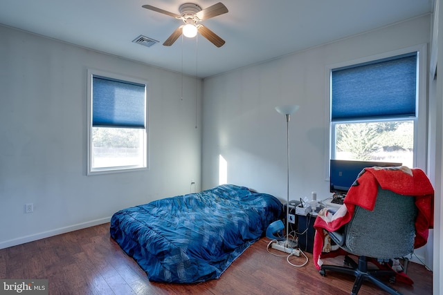 bedroom featuring dark hardwood / wood-style flooring and ceiling fan